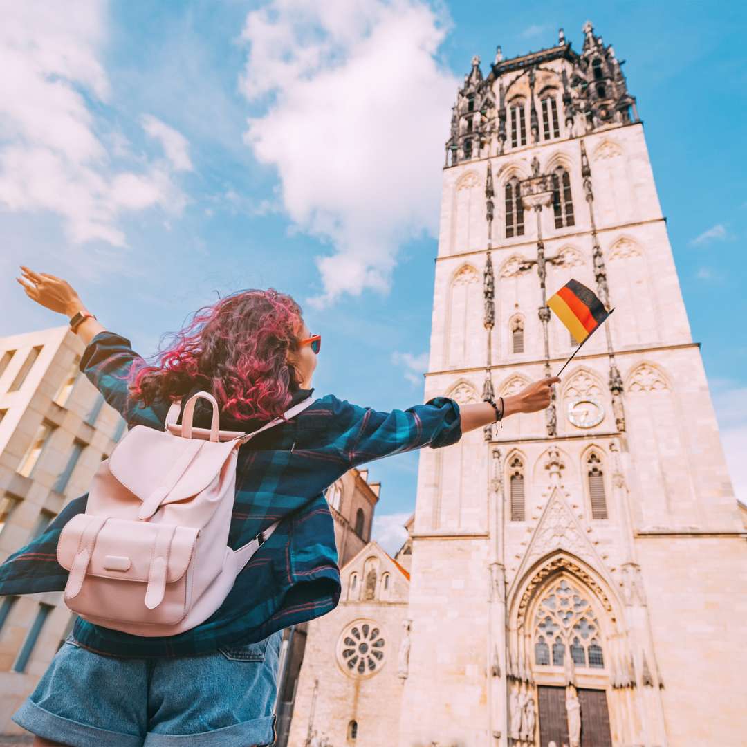 German building with a student standing outside
